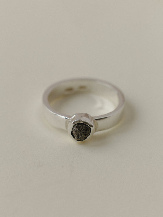 Ring with a large dark diamond