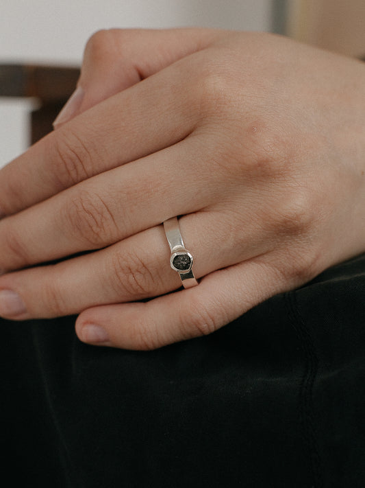 Ring with a large dark diamond