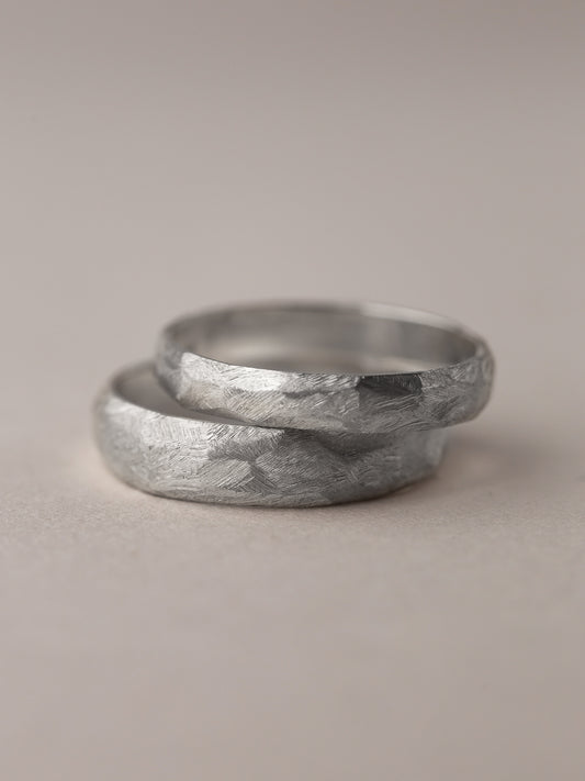 A pair of faceted wedding rings